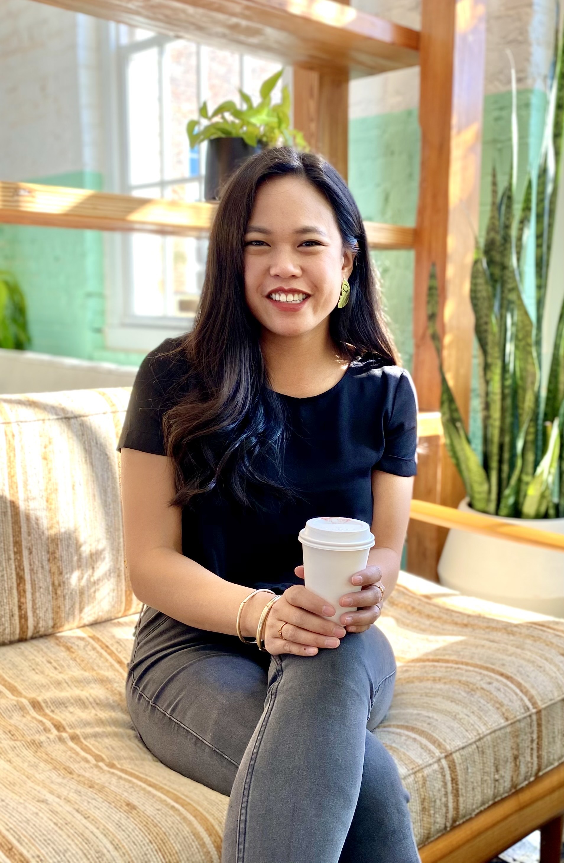 Connie Tran, full-stack web developer, enjoying a cup of coffee