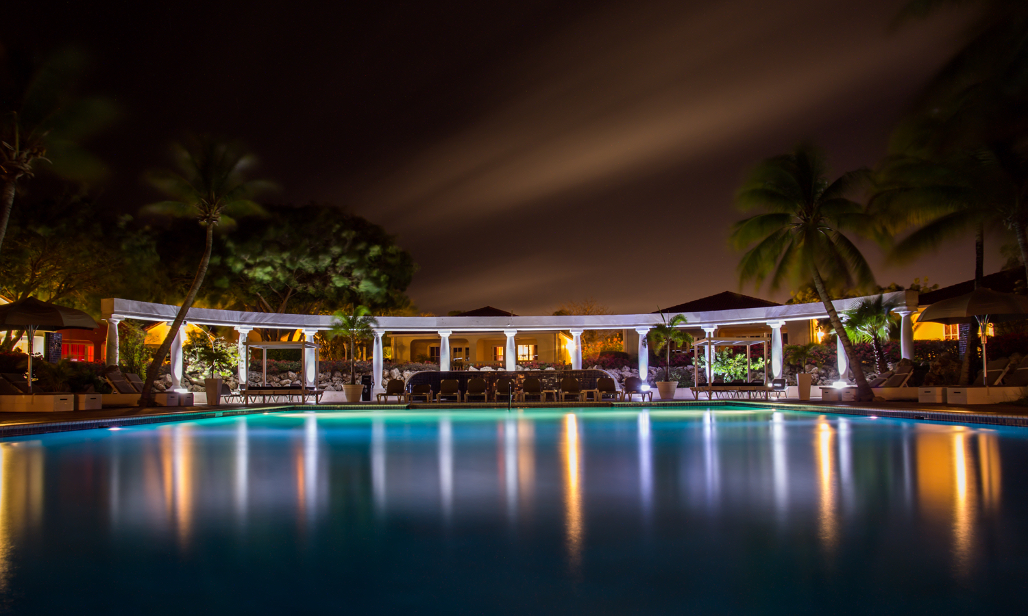 Hotel pool with open cabana at night